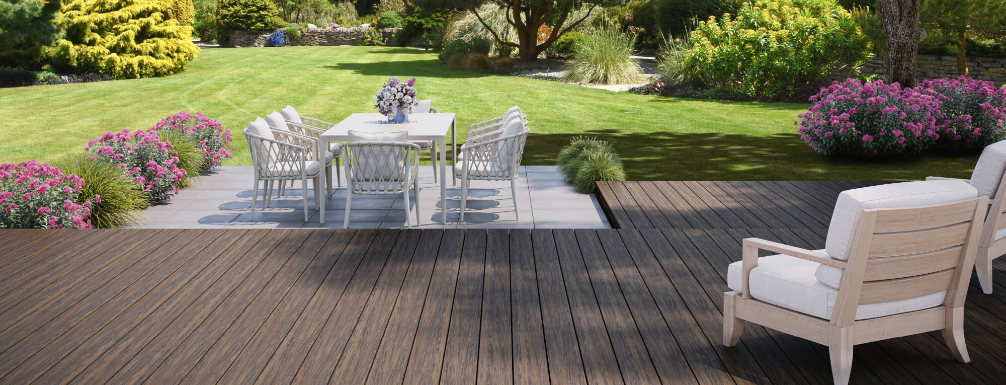 An open garden with two chairs on the Voyage wood look decking